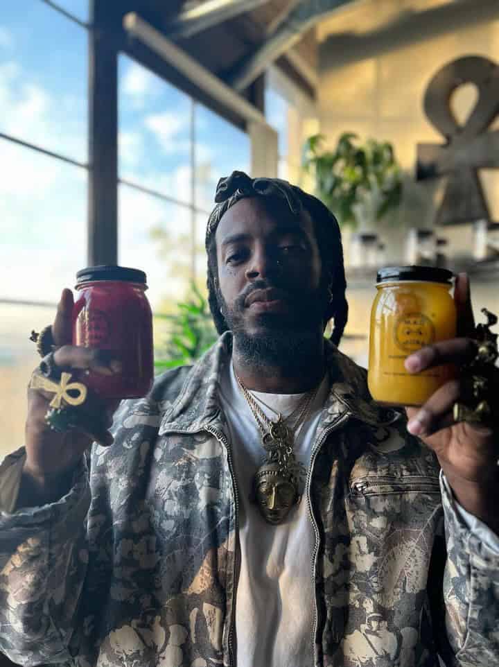 M.A.D MO$$ founder holding two sea moss gel jars
