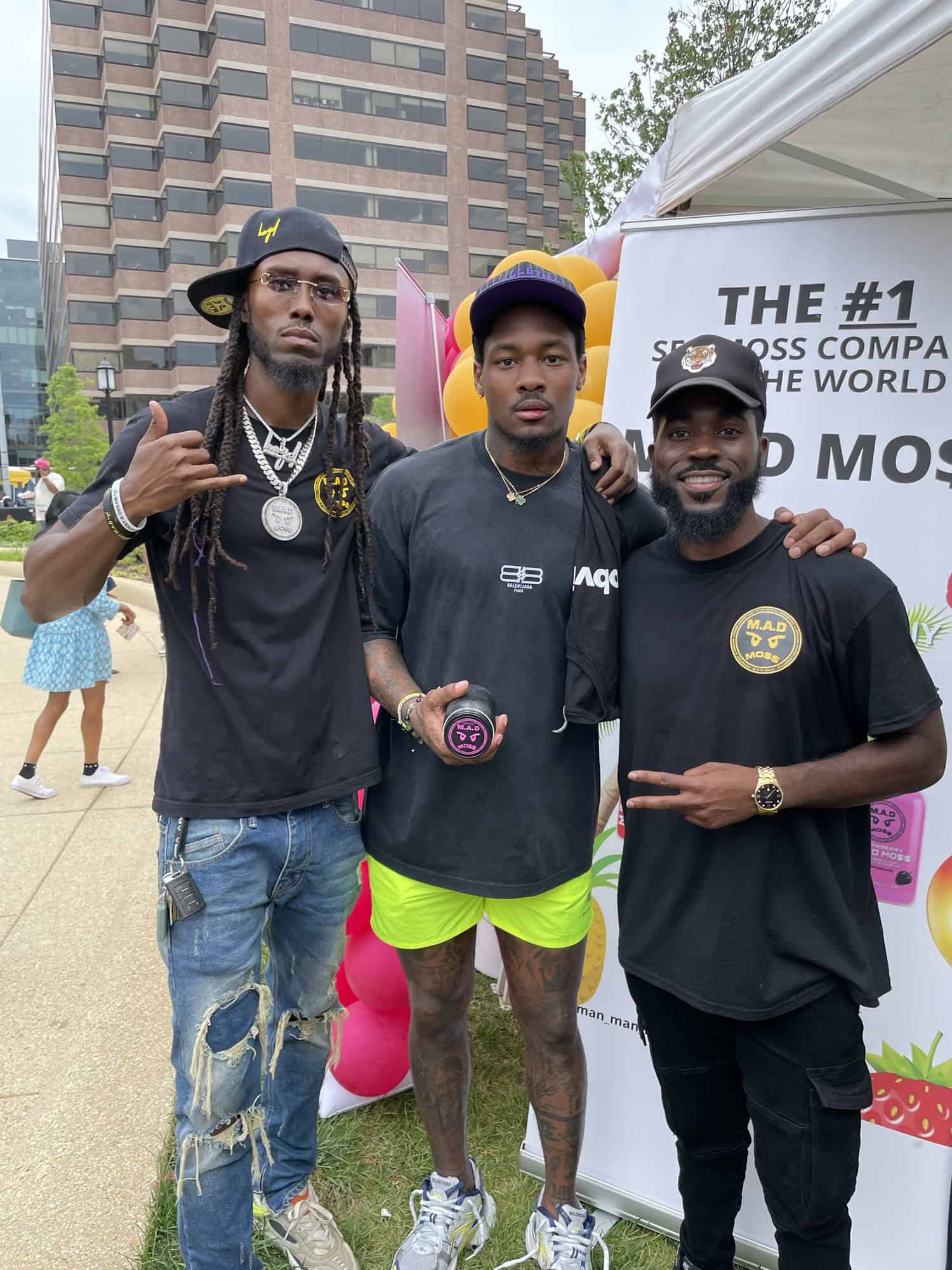 The M.A.D MO$$ crew at a community event tent