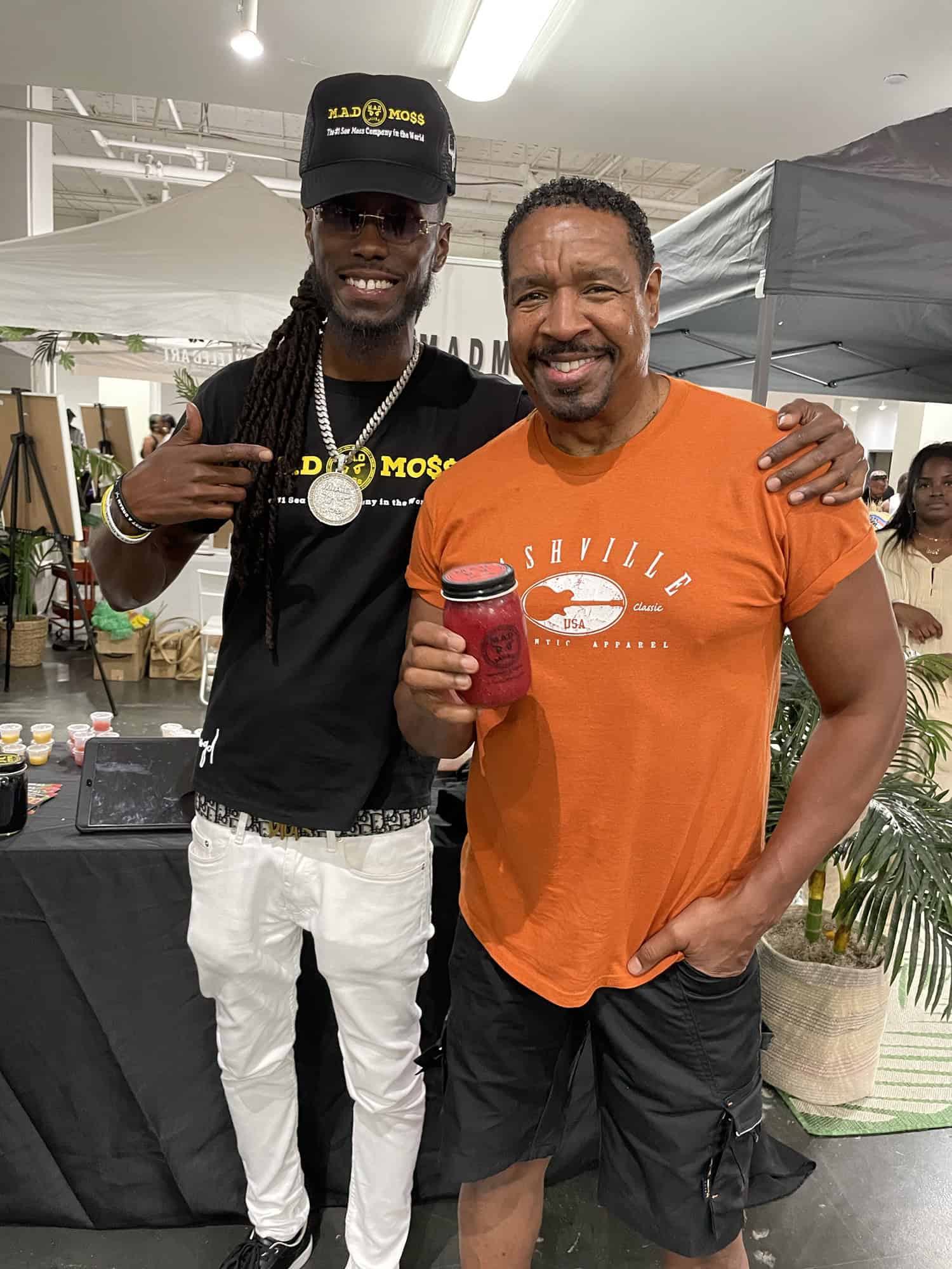 The founder and a happy M.A.D MO$$ customer with a jar